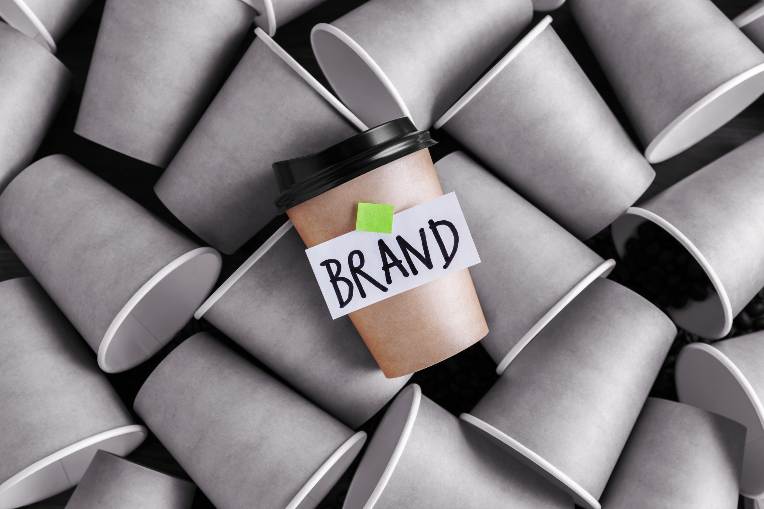 Branding illustration shows plain paper cups and a branded one that stands out